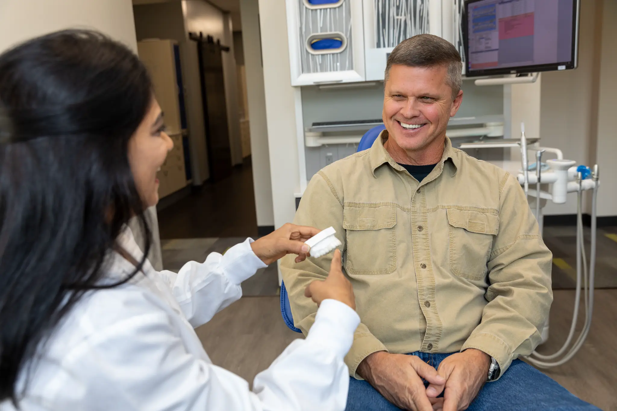 VSP Dental doctor discussing implant care with a patient