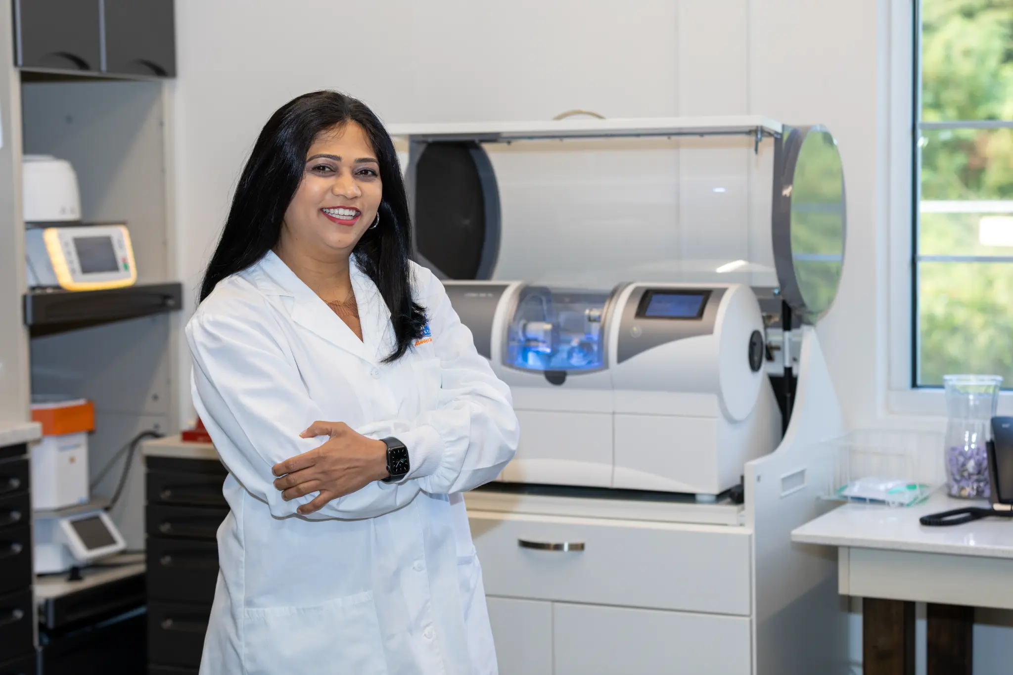 Dr. Vaibhavi Patel beside in-office dental technology
