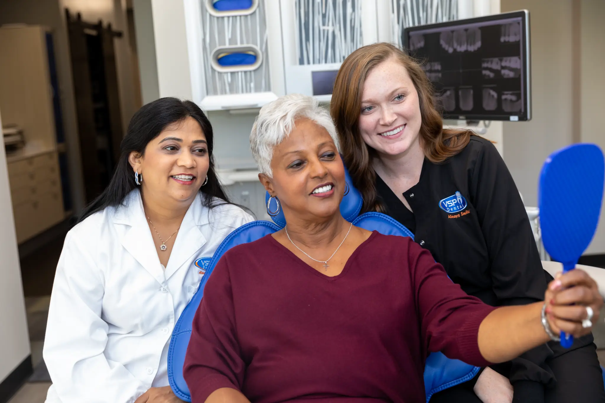 VSP Dental team member and patient discussing care in the treatment room